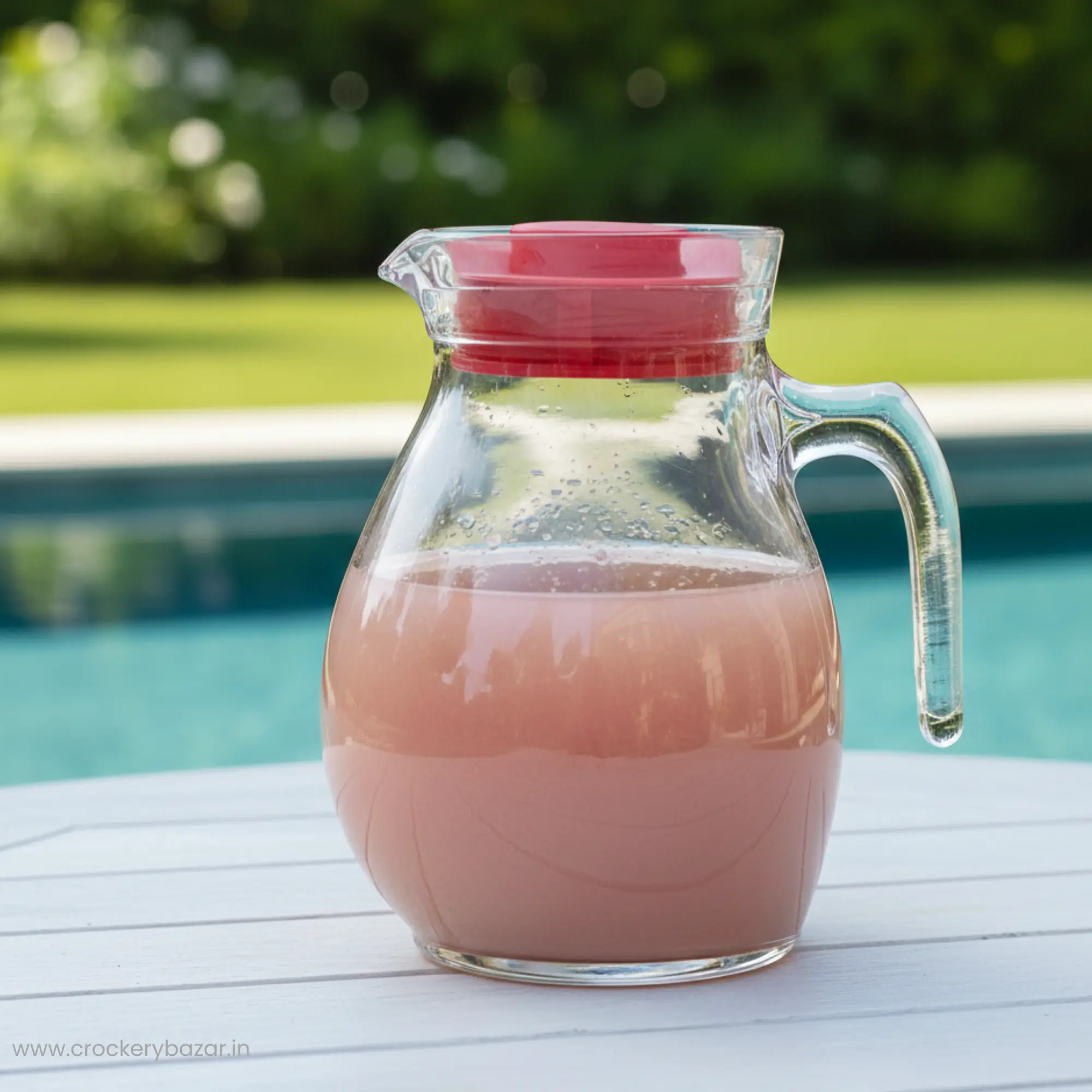 Bormioli Rocco Sangria glass jug for water serving on a white outdoor table with a refreshing beverage.