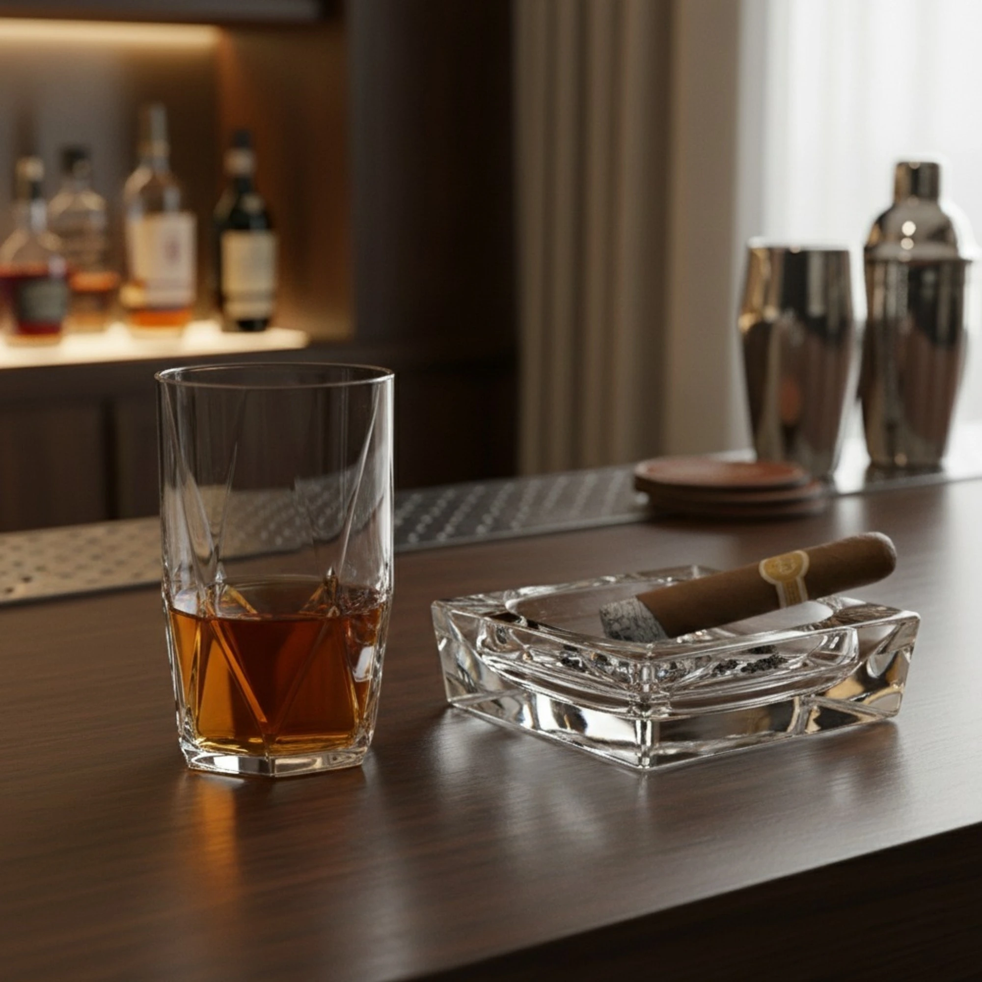 Premium Topazio 360ml whiskey glass by Nadir Figueiredo featuring a round rim and unique diamond-cut geometric base on a luxury home bar counter.