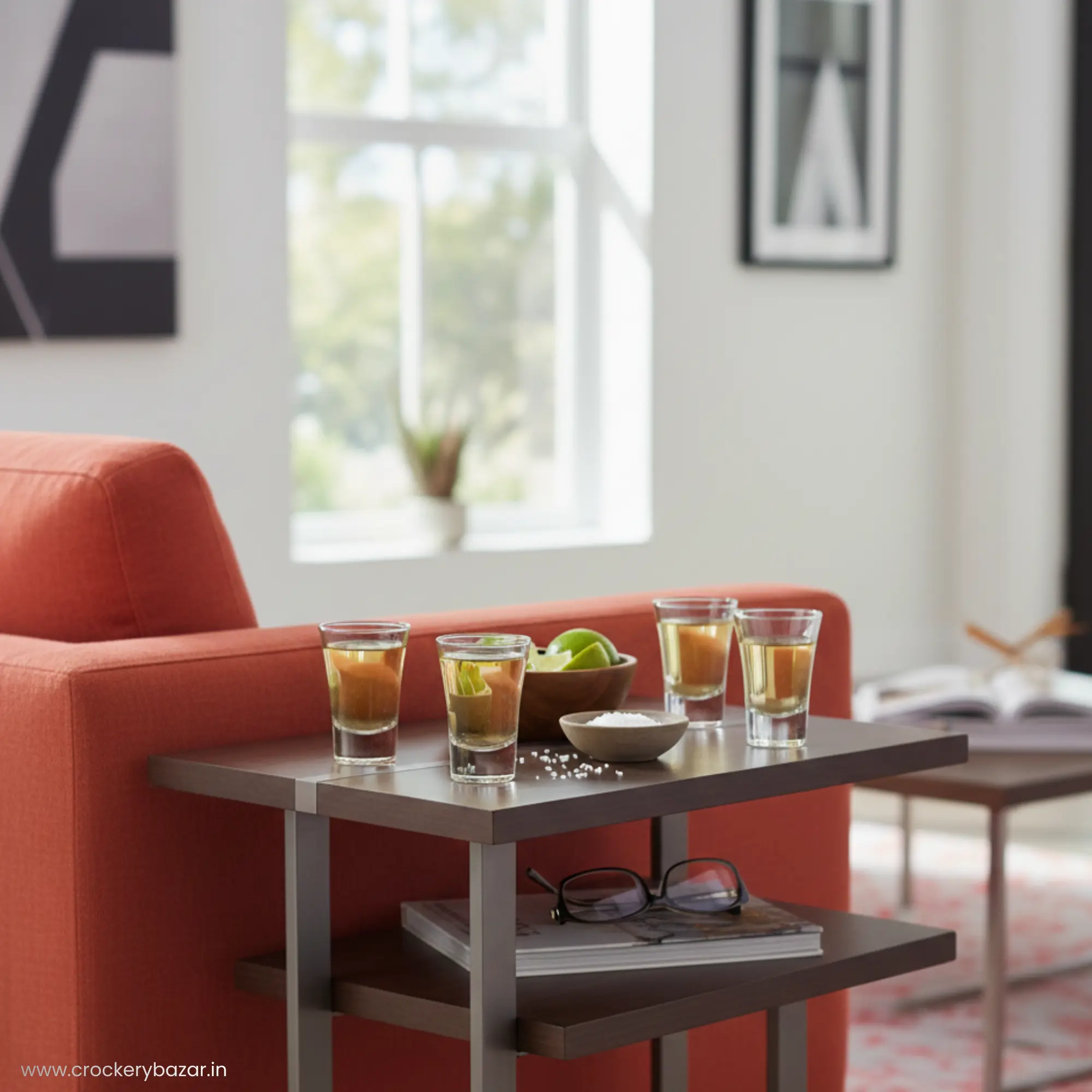 Four Nadir Ole shot glasses and a bowl of limes on a modern side table in a bright living room.