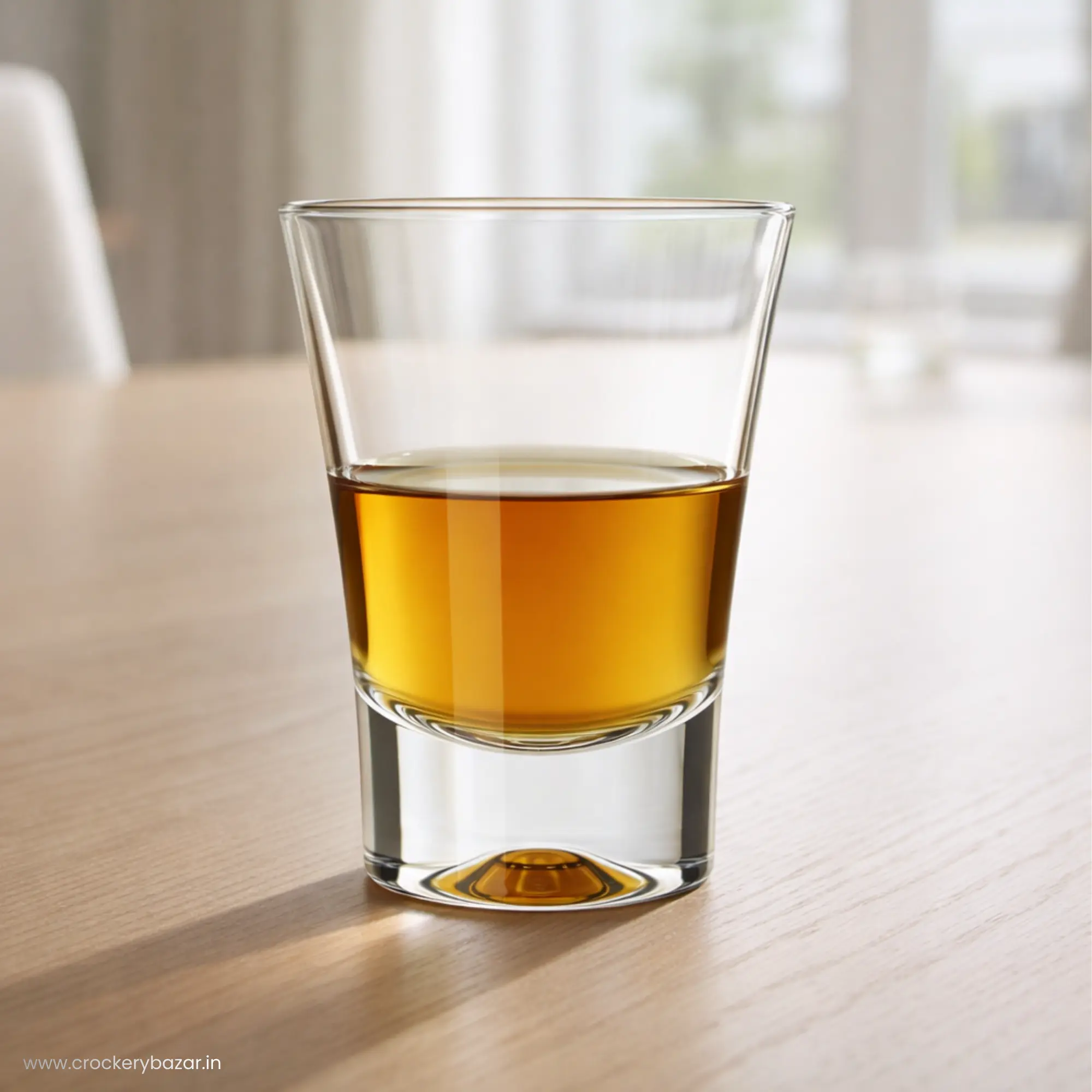 Single Nadir Ole 60ml shot glass filled with amber liquor on a wooden tabletop.