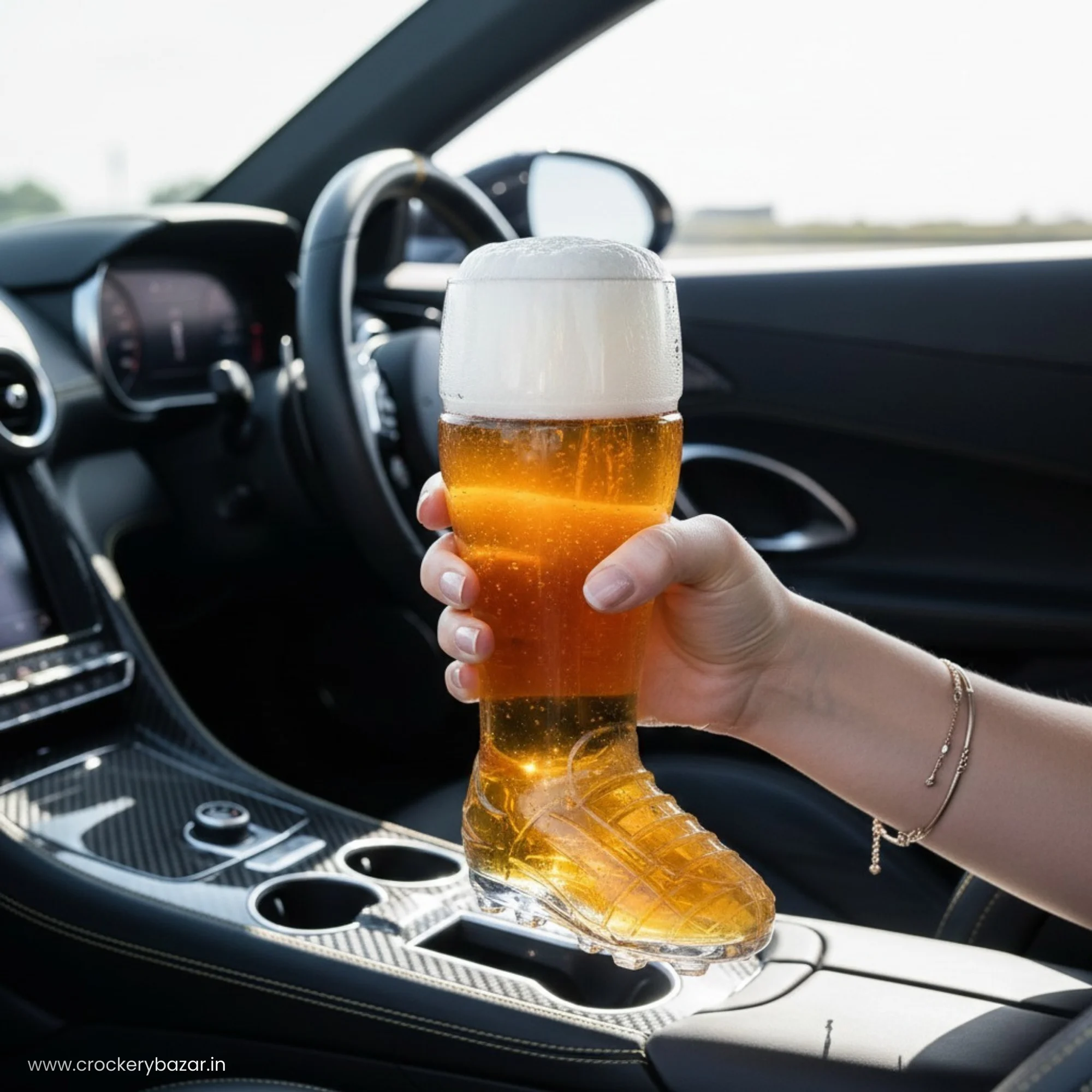 Hand holding a filled Borgonovo boot beer glass inside a luxury car interior. Image Title: Borgonovo Boot Glass Travel Lifestyle.