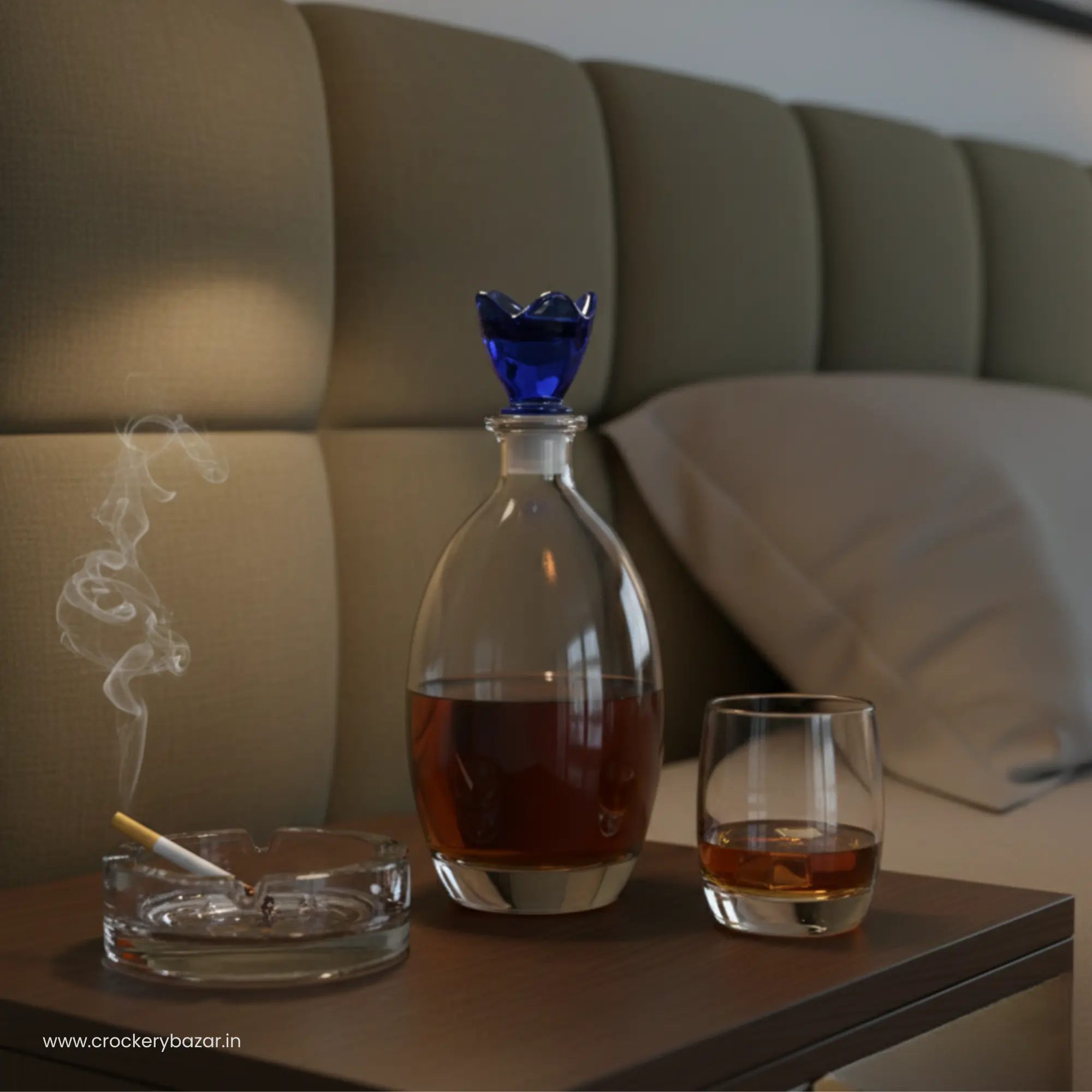 Bormioli Rocco Bouquet Decanter 780ml with blue lid on a bedside table next to a glass of bourbon and an ashtray.