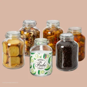 A group of five Bormioli Rocco Fido 5L round glass jars filled with toast, dry fruits, pickles, coffee beans, and traditional preserves.