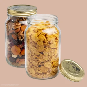 Two Bormioli Rocco Quattro Stagioni 1L square glass jars filled with dry fruits and cornflakes, showing the iconic outer body engraving and golden lids.
