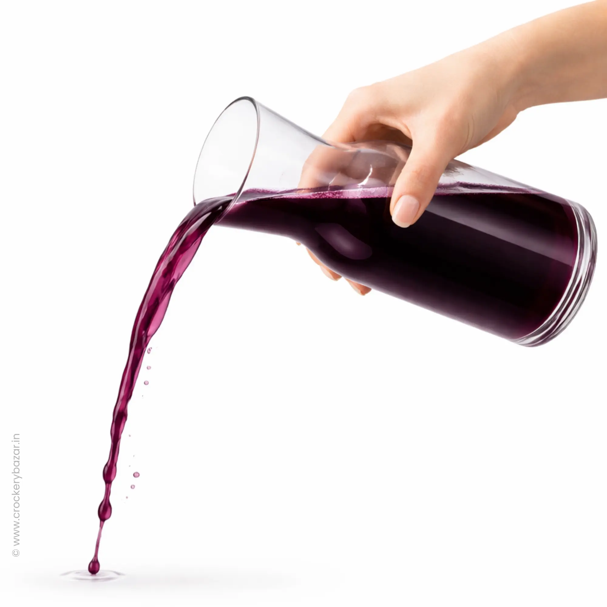 Bormioli Rocco Aquaria 750ml clear glass carafe pouring juice, sold by Crockery Bazar.