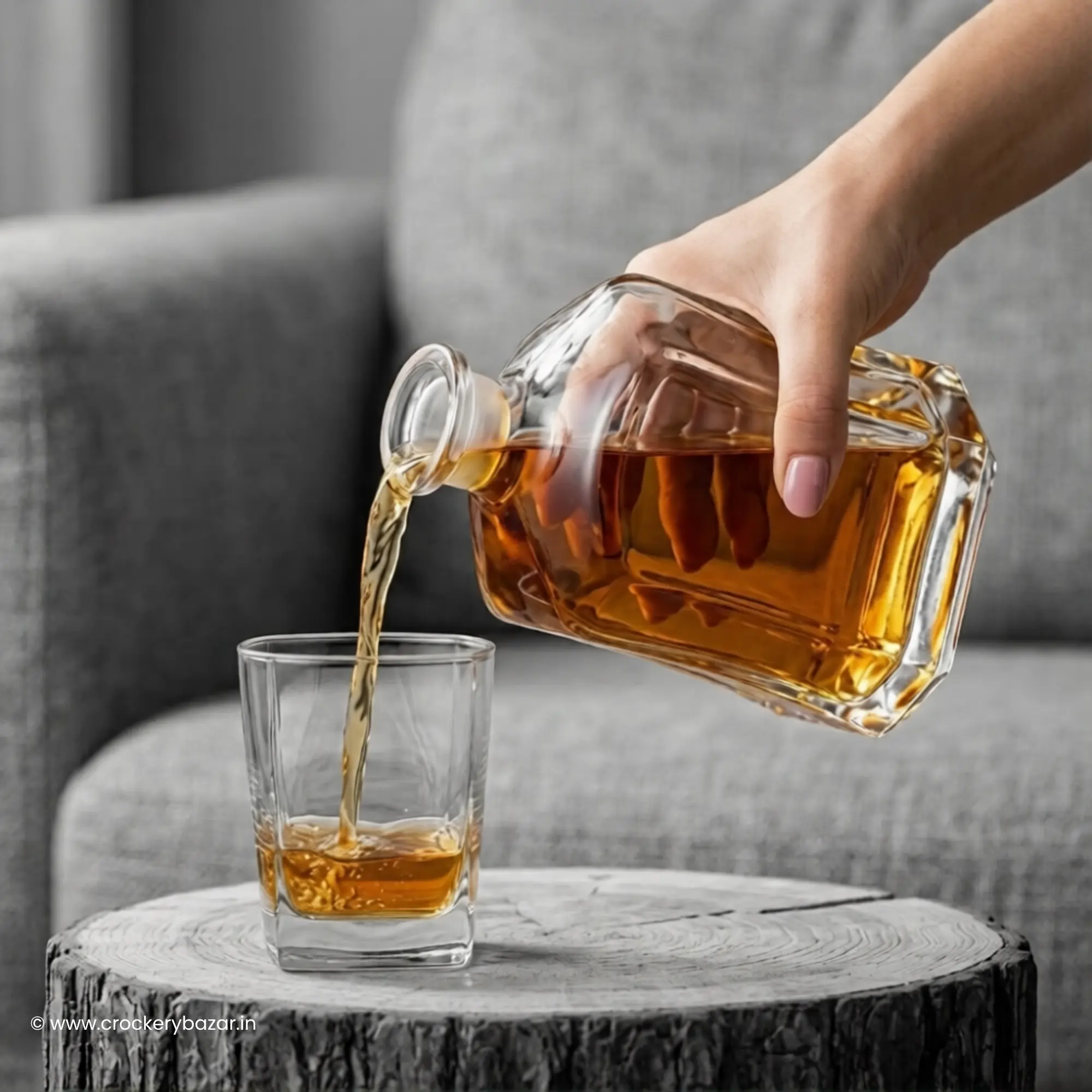 Bormioli Rocco Capitol decanter for whiskey pouring into matching whiskey glass on rustic table