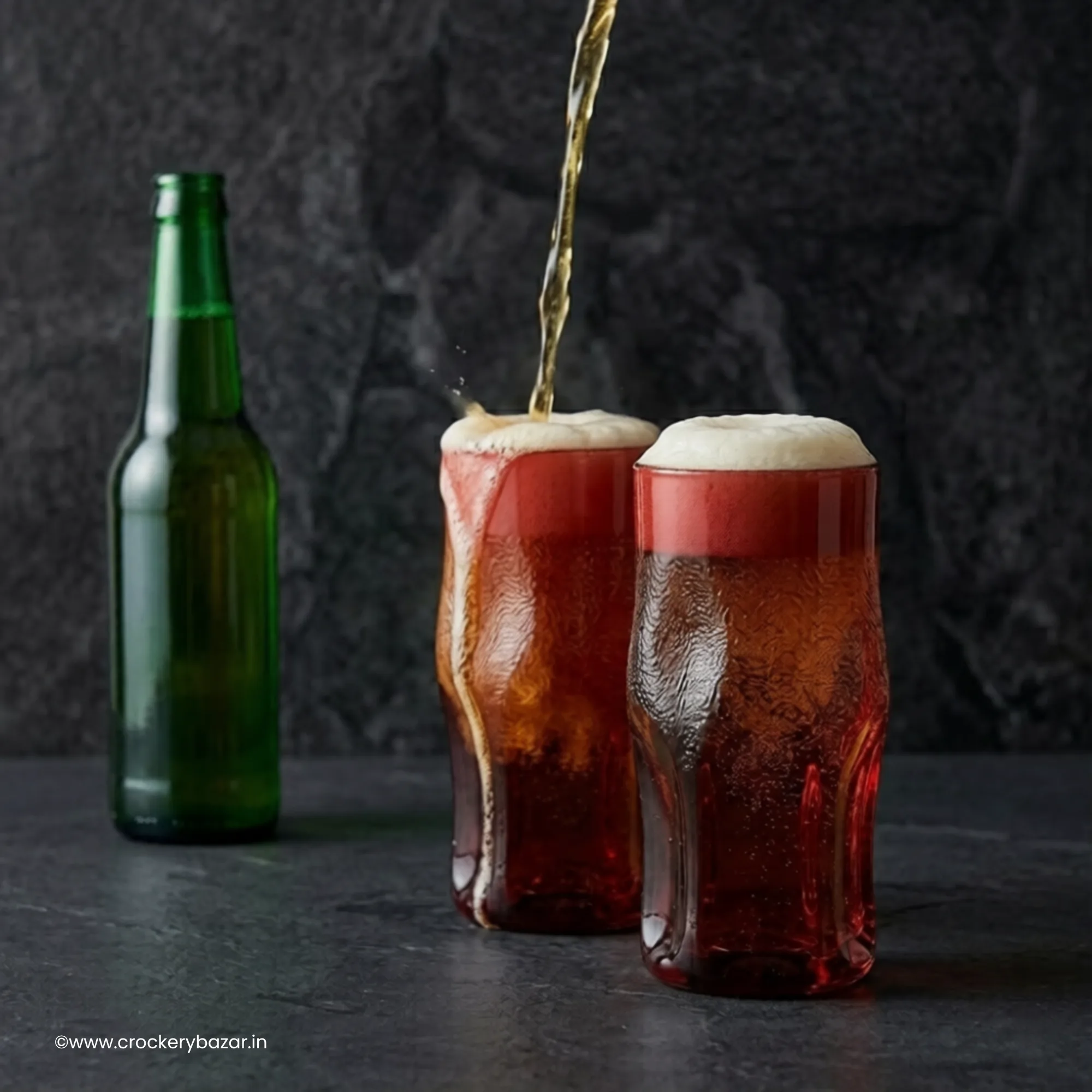 Beer being poured into Bormioli Rocco Sorgente red cooler glasses for premium beer serving and party presentation
