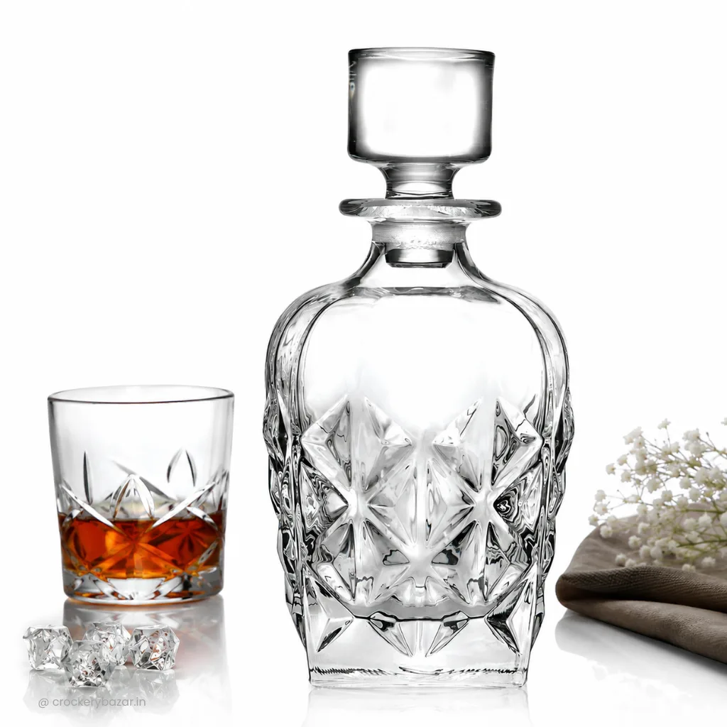 Crystal cut glass decanter beside a whiskey tumbler, illustrating a classic decanter for serving spirits.
