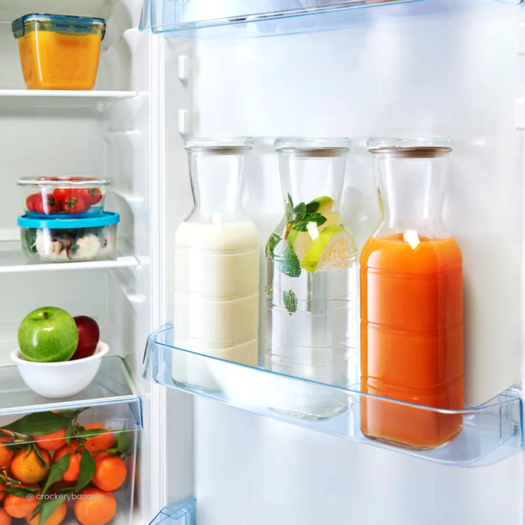 Glass refrigerator door jugs storing milk, juice and infused water for fresh everyday beverage storage.