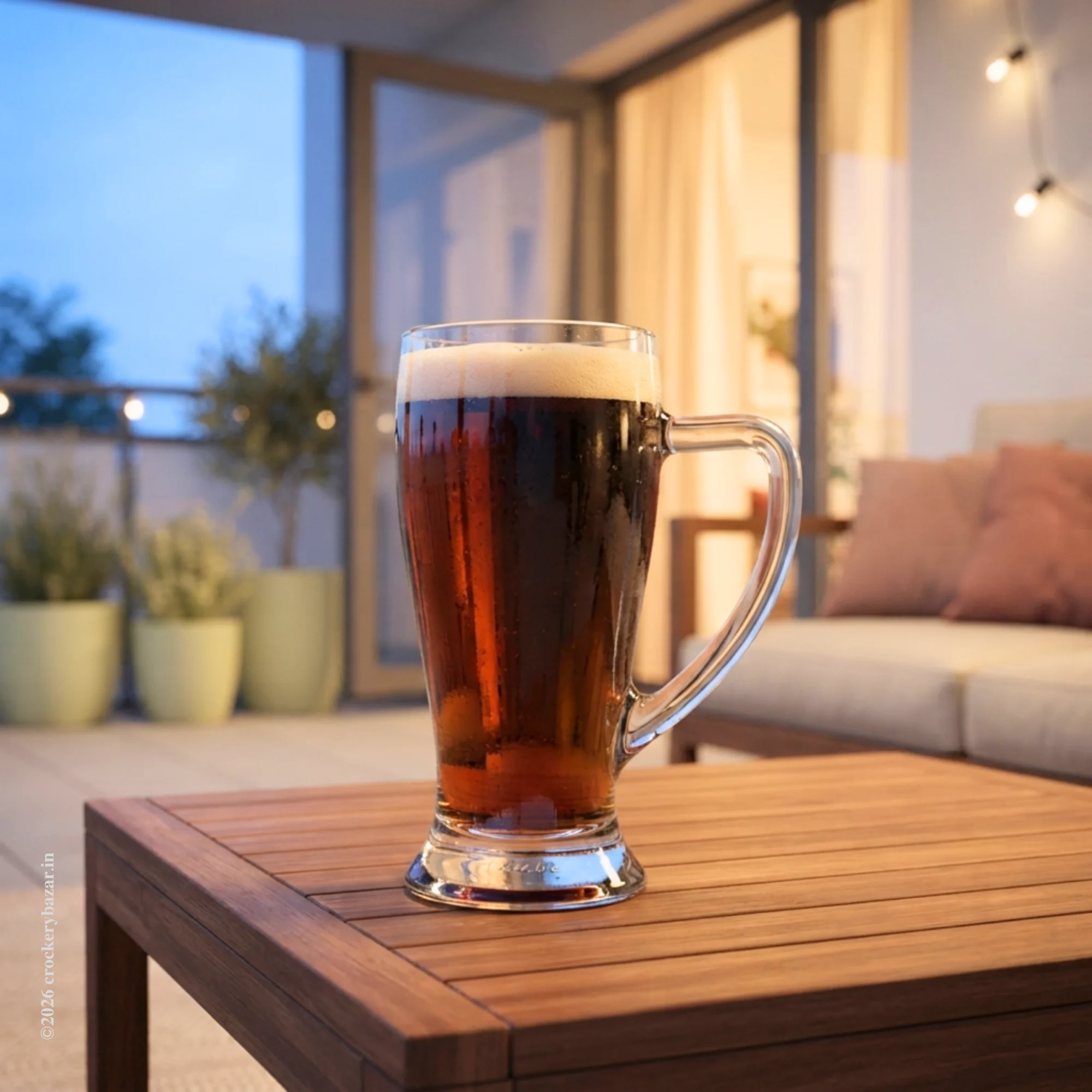 A single Bormioli Rocco Baveria unique glass beer mug 400 ml filled with dark ale on a wooden balcony coffee table at twilight.