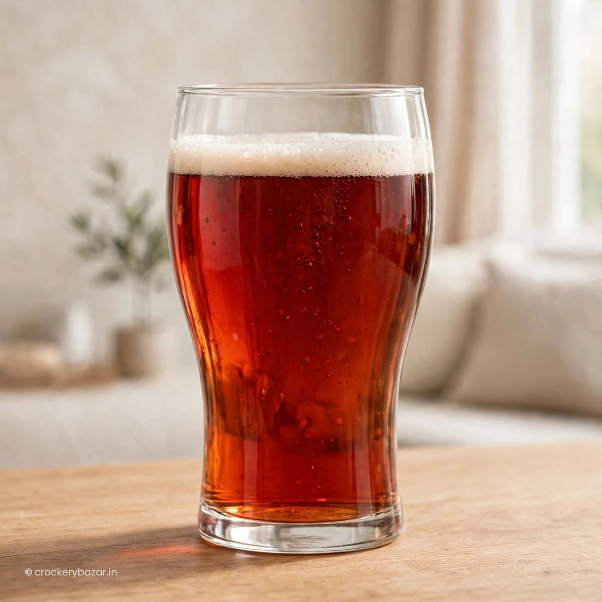 Single luminarc beer glasses style filled with beverage on a wooden table inside a home interior