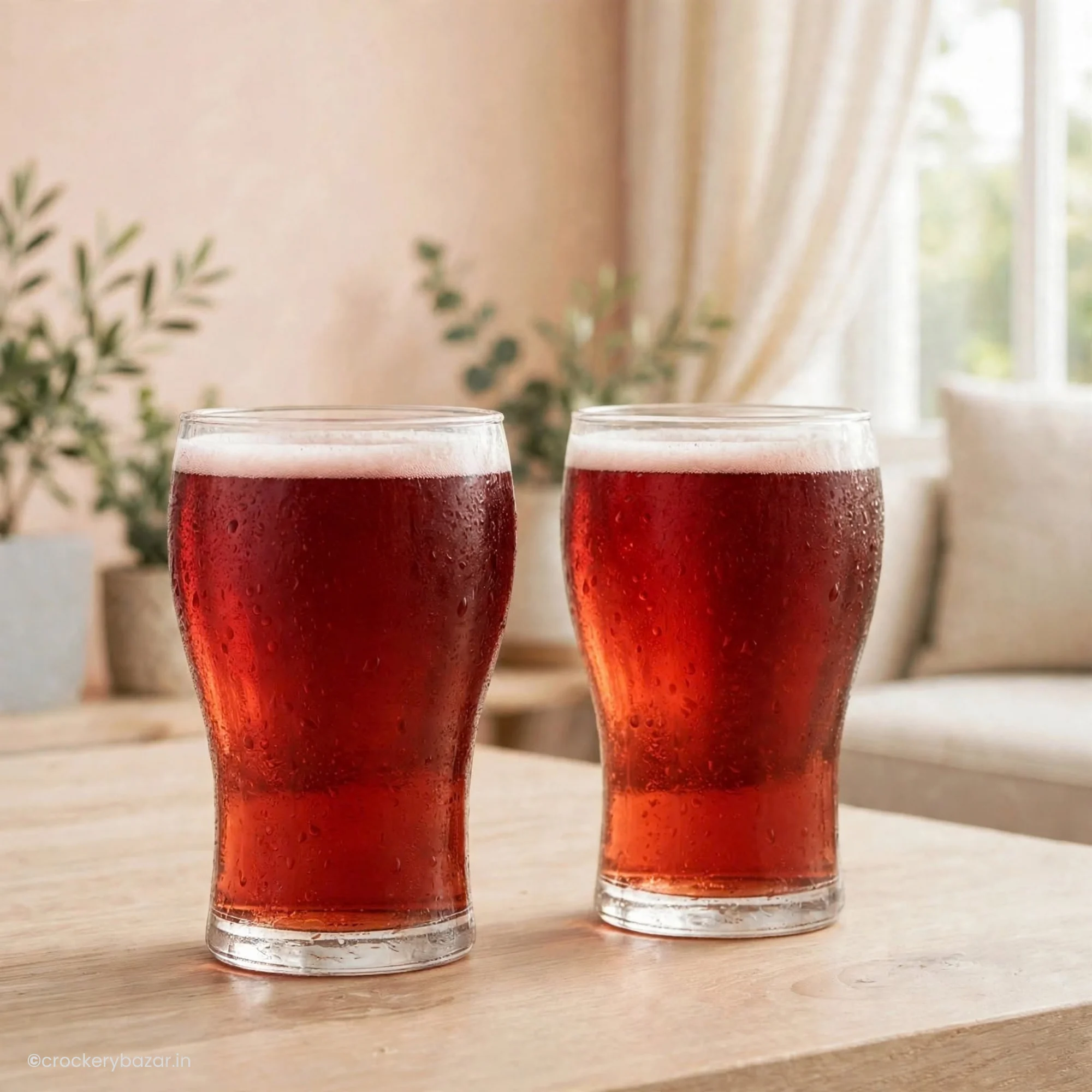 Pair of luminarc beer glasses filled with dark beverage displayed on a wooden surface